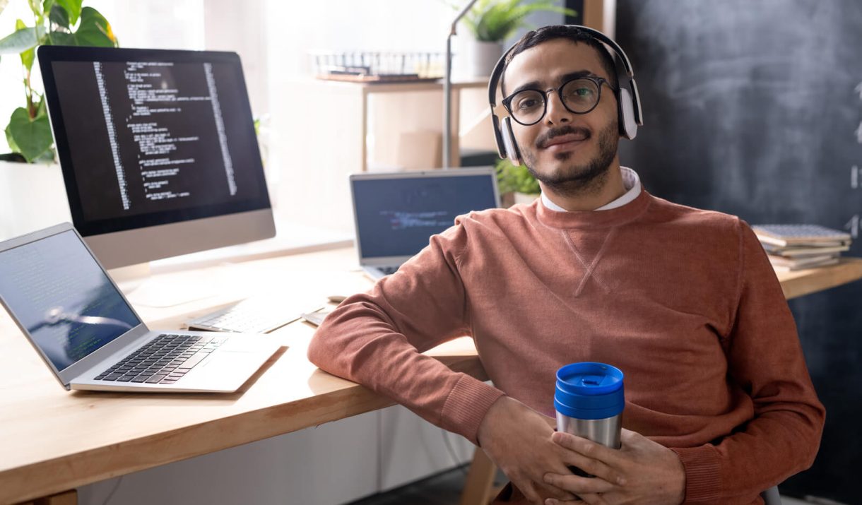 handsome programmer in headphones listening to mus 2023 11 27 04 56 48 utc